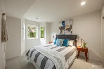 On the first floor/lower level there are two additional bedrooms. This bedroom overlooks the front of the house with garden views.