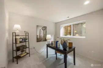 The 4th bedroom with a window overlooking the back garden & landscaping.