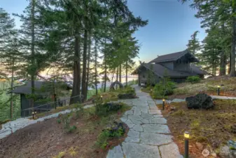 Flagstone pathways and stone staircases with hand railings connect the 4 structures and blends them into the native surrounding vegetation.
