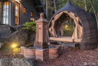 Outdoor lounger with water feature.