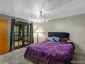 Primary suite, with french doors that lead to the sunroom
