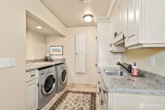 The Chef’s kitchen with oversized granite island, custom cabinets with pull out drawers offers hidden gems: trash compactor, double-oven, Sub-Zero refrigerator, undercounter lighting and floor lighting with westerly views at every turn.