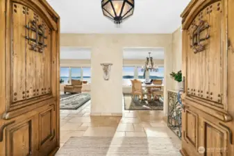 Enter through the magnificent solid wood doors, welcomed by natural stone floors and rooms filled walls of windows, that bring in the sunlight and beautiful vistas.
