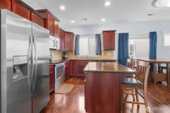 Island counter and stainless appliances in open Kitchen.