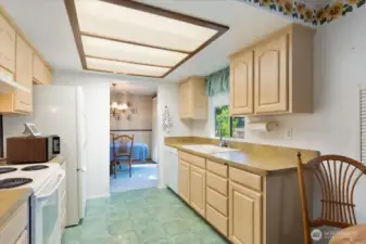 spacious kitchen with window overlooking backyard