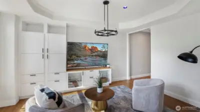 The built-in shelving and large white cabinets create a stylish focal point while giving the space a warm and welcoming feel!