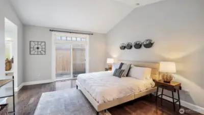 Enjoy a bright and airy primary bedroom on the main floor, complete with a sliding door to the backyard and direct access to a private en suite bathroom