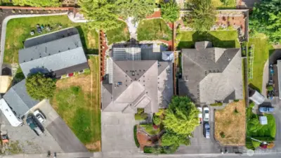 A sweeping view of the home showcases the broad driveway and beautifully maintained landscaping
