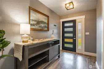 Welcoming foyer w/closet around corner & half bath to right