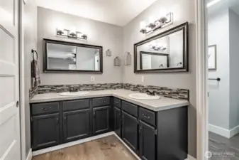 Ensuite bath w/2nd closet, dual vanity, tons of cabinets & separate room for shower & commode