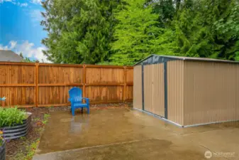 Huge concrete patio w/garden shed tucked back in corner