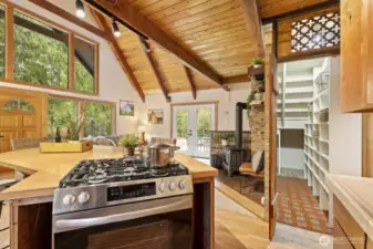 Generous walk-in pantry with built-in shelving and gas range for the home chef.