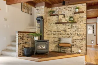 Cozy temperature controlled fireplace with brick detail.