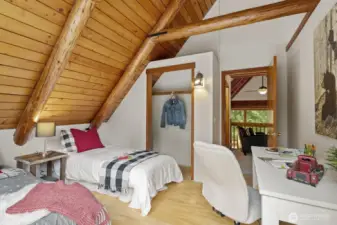 Spacious second bedroom with ample closet space, and stunning exposed beams.