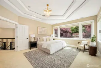 Luxurious primary suite w/ fireplace & spa-like ensuite featuring heated floors, freestanding tub, dual vanities & walk-in shower.