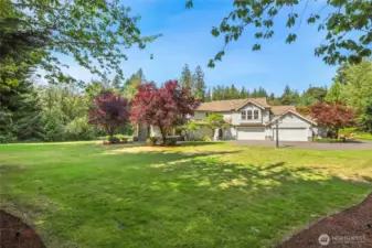 Stunning estate nestled on private 3.840-acre lot, featuring elegant architecture, lush landscaping, & serene surroundings