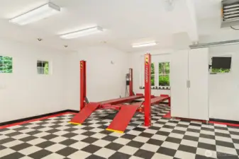 Oversized 5-car garage features abundant built-in storage and a heavy-duty 4-post lift rated to 9,000 lbs—ideal for auto enthusiasts