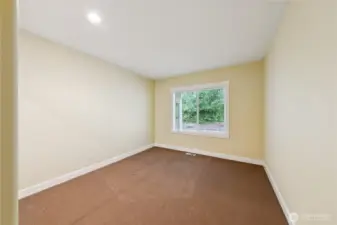 The second guest bedroom is generously sized and located toward the back of the home, offering peaceful views of the Forest Lands.