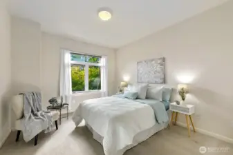 Spacious primary bedrooms is flooded with southern exposure light.