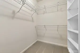 Primary suite walk-in closet is sure to please.