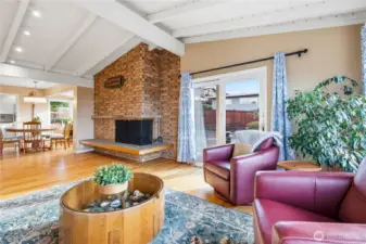 Mid-century modern lines and statement piece fireplace anchors the dining and living areas.