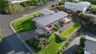 Stairs from the back patio descend to additional outdoor activity area.
