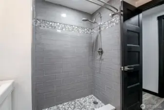 Fully tiled shower in the hall bath