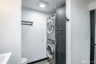 Stacked washer and dryer in primary bathroom