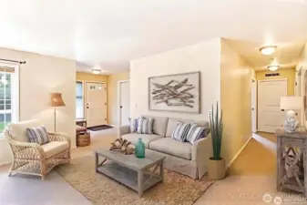 The entryway opens into a bright, inviting living room with neutral tones and an easy, comfortable flow through the home.