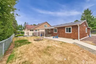 The spacious backyard includes a cozy fire-pit area and a generous side yard that offers convenient RV parking.