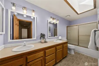 Shared dual vanity sink full bathroom.