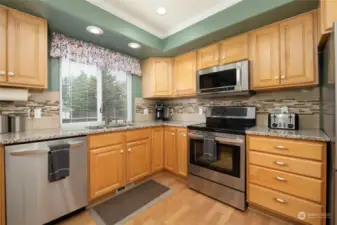 Bright kitchen with upgraded floors and countertops.