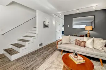 Living area- The stairs lead up to two large bedrooms and a redone tiled full bath.