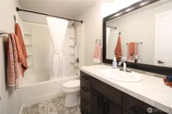 Upstairs has a full bathroom with a lovely tile floor.