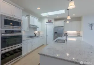 Open Kitchen -Double Ovens, natural gas cooktop, SS Appliances and a Pantry