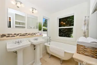 Recently remodeled primary bath with clawfoot tub & dual pedestal sinks!