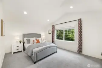 Primary bedroom with vaulted ceilings