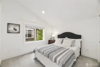 Second en suite upstairs bedroom with vaulted ceilings