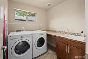 Dedicated laundry room with a sink and countertop