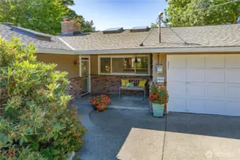 Sweet sitting porch with both single step and sloped walkup.