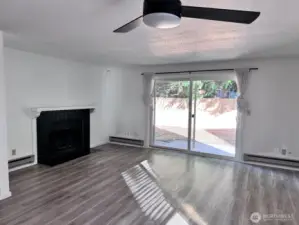 Unit 12722 - Large living room with LVP flooring and wood fire place