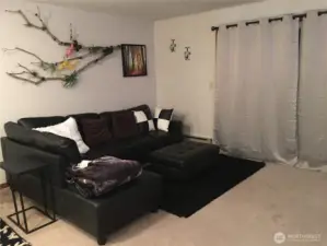 Unit 12724 - Living room has sliding door open to the fenced yard