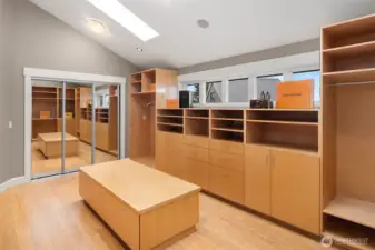 An incredible walk (around) in closet with private laundry for the top floor.