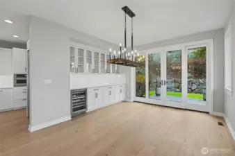 Bathed in natural light, the dining room offers convenient access to the backyard, enhancing the home’s seamless indoor-outdoor living.