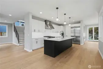 Stunning chef’s island with seamless undermount sink, abundant cabinetry, and integrated dishwasher, creating the ideal spot for everyday meals or gatherings.