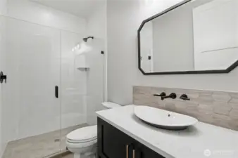 Stylish main-level ¾ bath with contemporary finishes, offering elegance and convenience.