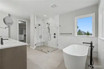 Luxurious primary bathroom with a soaking tub, generous shower, and dual sinks, creating a serene spa-inspired retreat.