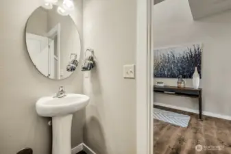 1/2 bath located next to den/ home office. Photos are for representational purposes only.  Colors and finishes may vary.