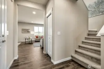 Extended laminate flooring thru entry, family room and kitchen. Low maintenance. Photos are for representational purposes only.  Colors and finishes may vary.