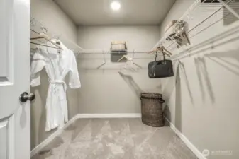 Primary suite walk in closet. Photos are for representational purposes only.  Colors and finishes may vary.